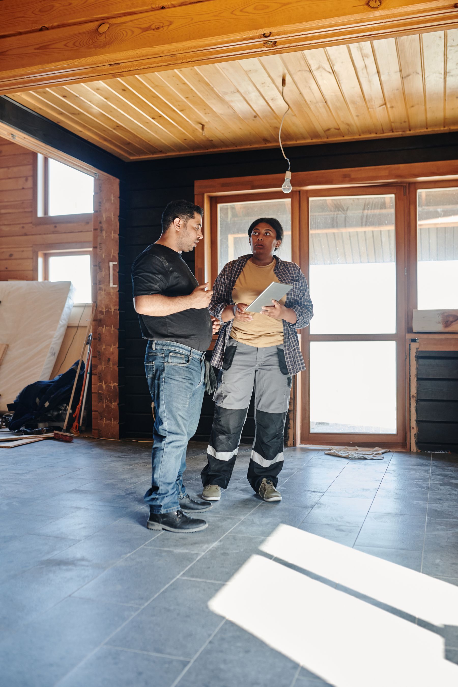 A homeowner and tradesperson reviewing renovation work together